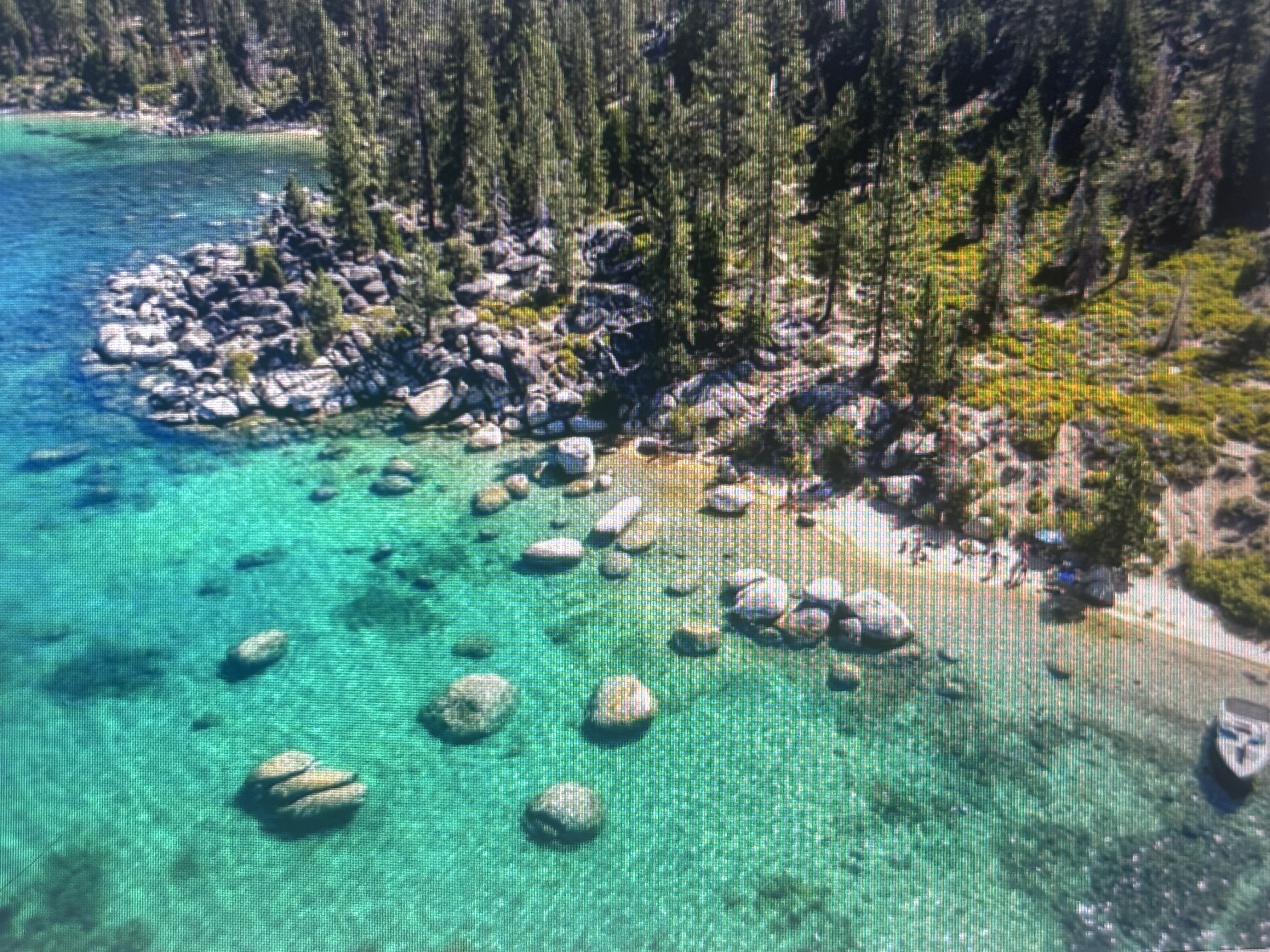 Clear alpine lake water over granite boulders