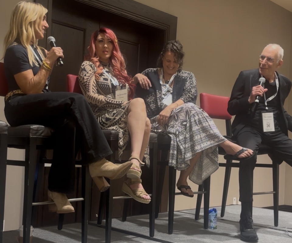 Loretta on an expert panel, microphone in hand